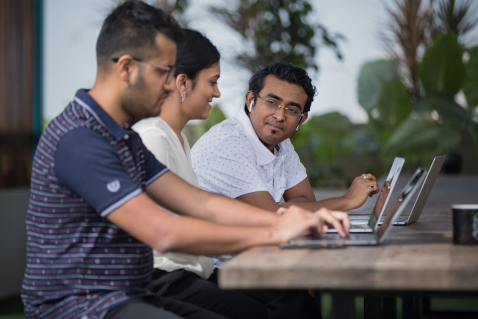Colleagues working together at a laptop