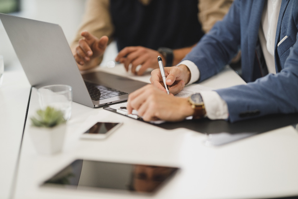 Two people reviewing a document together at a desk